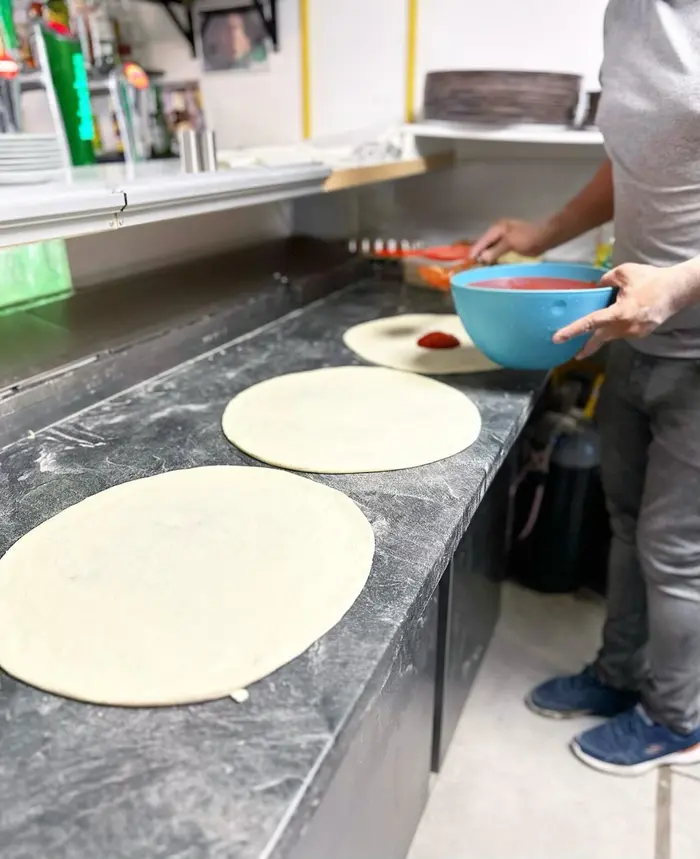 Handmade pizza dough being prepared at PizzaXXL